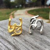 Adjustable Om Symbol Rings shown in Gold and Silver Finish